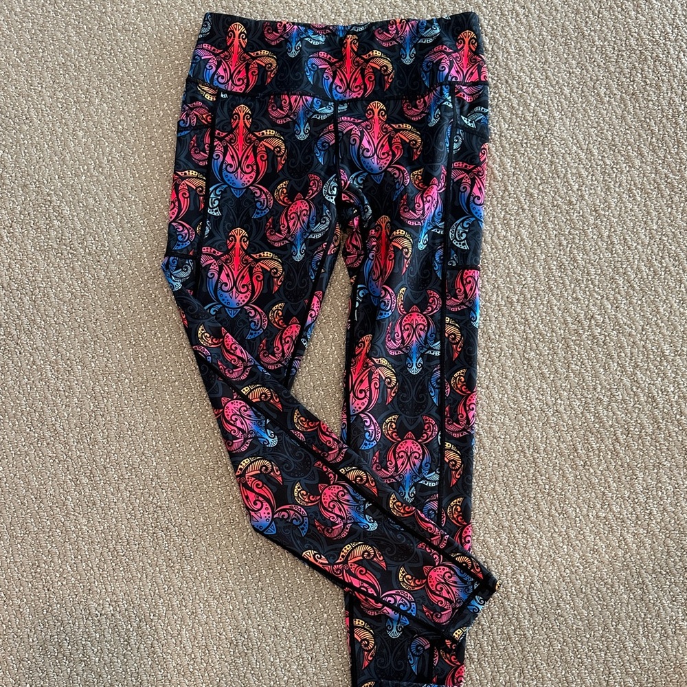 Black and rainbow leggings featuring sea turtles